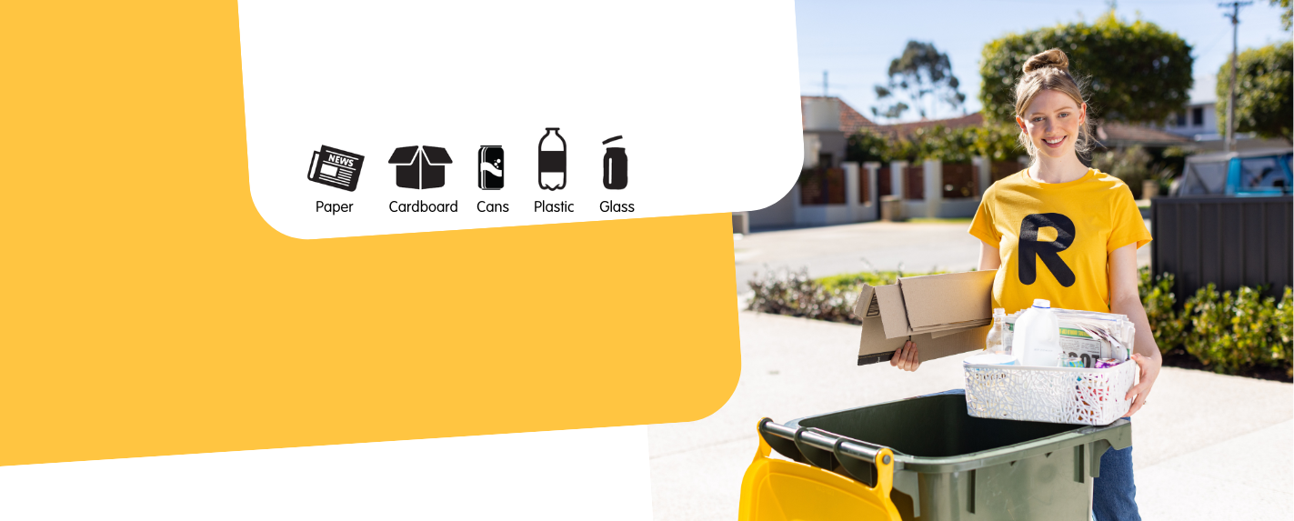 woman holding recyclables next to her recycling bin